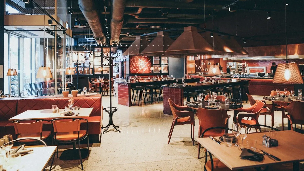 Modern restaurant dining room with warm ambient lighting and elegantly set tables creating a cozy seasonal atmosphere for holiday dining promotions
