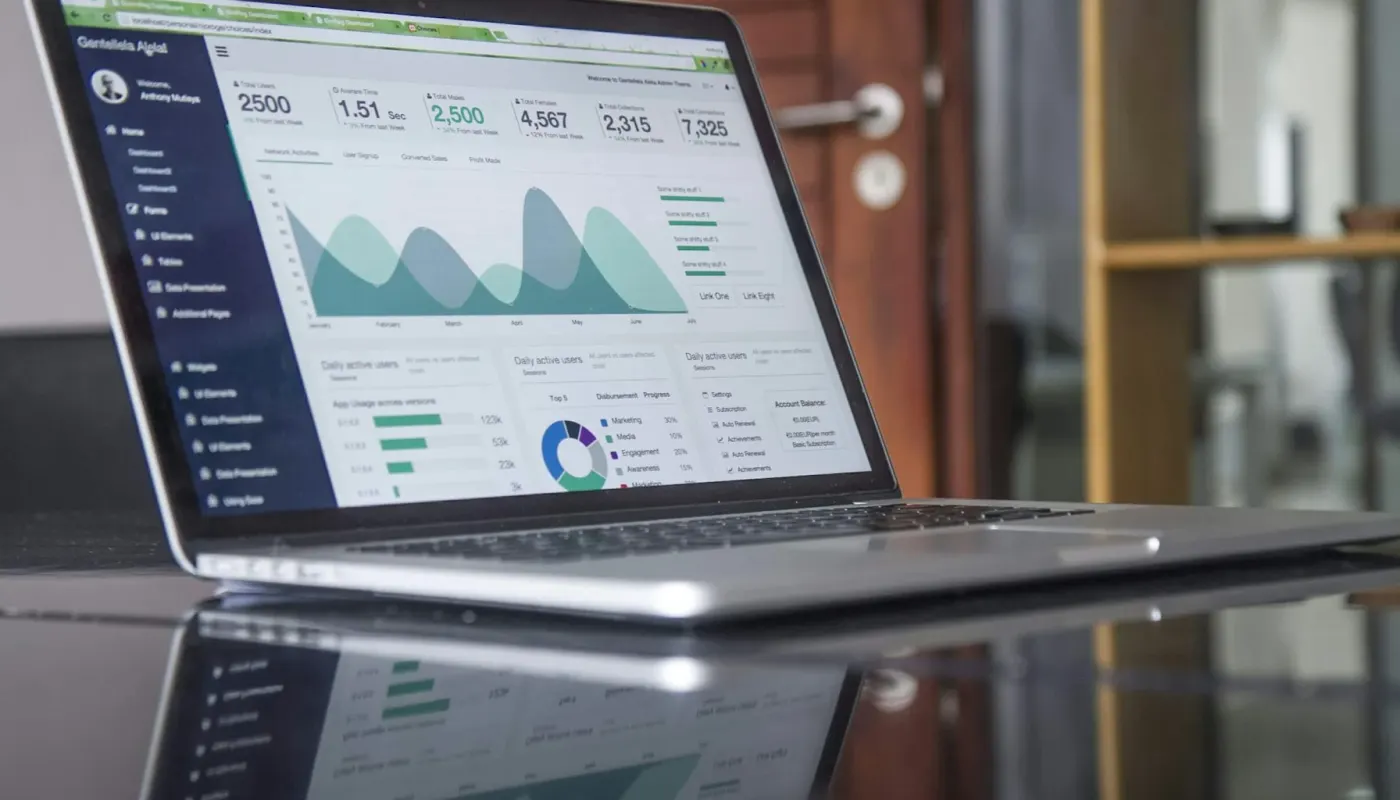 Tablet displaying marketing analytics charts and customer data on modern restaurant table with cyan ambient glow