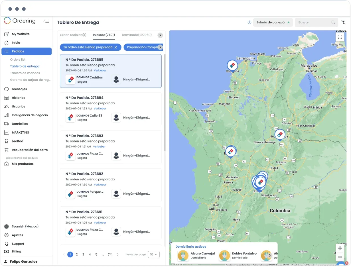 Delivery dashboard with orders in preparation, Domino's stores on a map of Colombia, and active delivery drivers