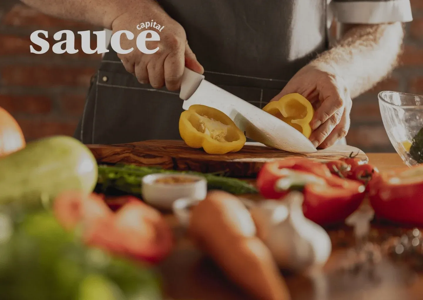 Sauce Capital cover image with the Sauce Capital logo over a cook slicing yellow peppers on a wooden board