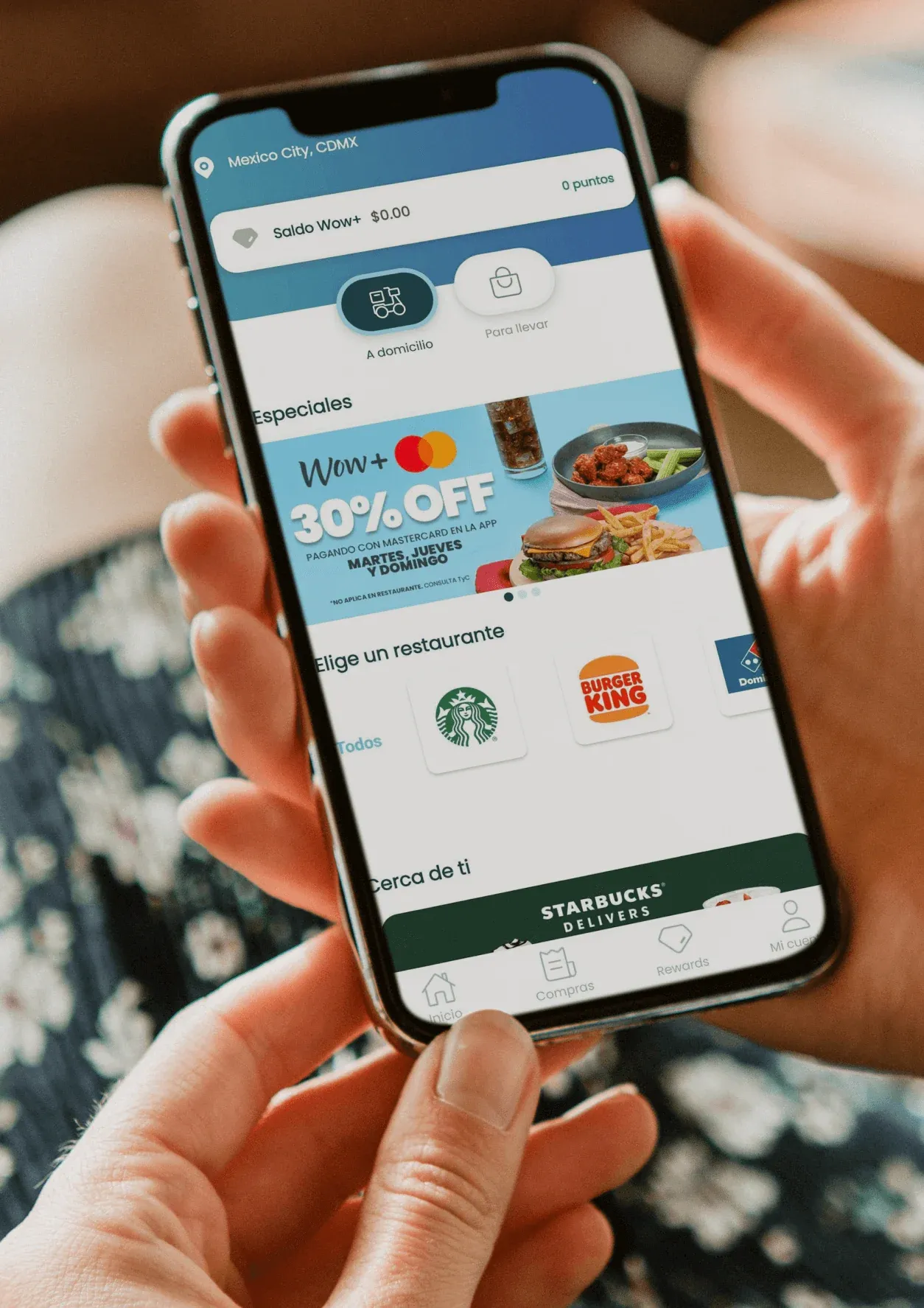 A guest using the WOW+ app, with a promotion banner and Starbucks and Burger King among the restaurants