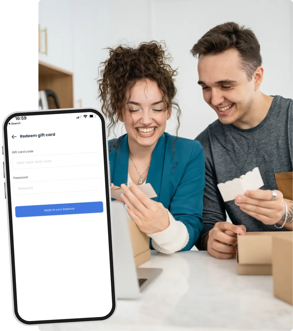 Redeem gift card screen on a phone next to a couple opening a gift box